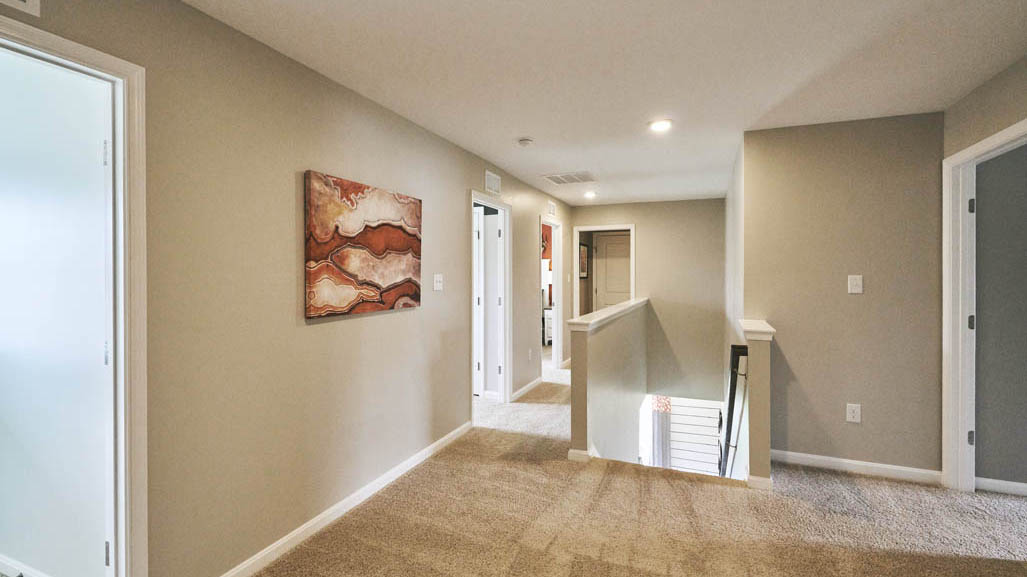 Three generously sized secondary bedrooms, and a spacious hall bathroom with double vanity complete the upstairs.