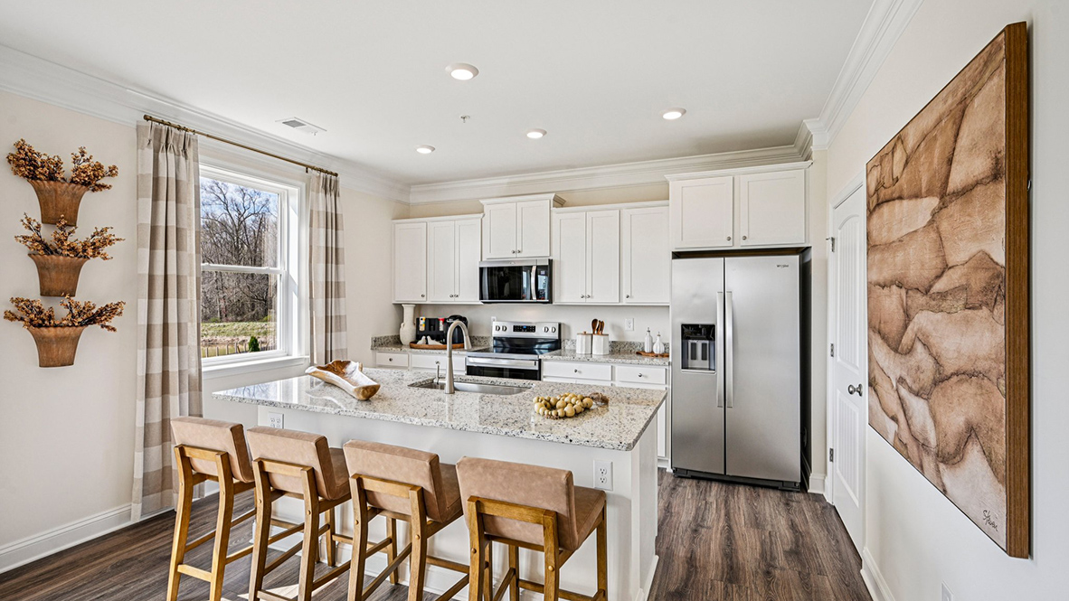 The well-designed gourmet kitchen features a spacious island with additional room for seating.