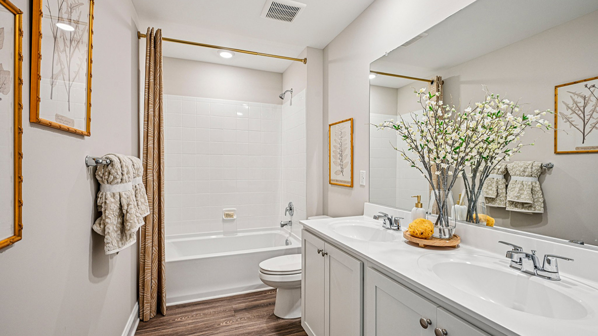 A spacious hall bathroom with double vanity completes the upstairs.