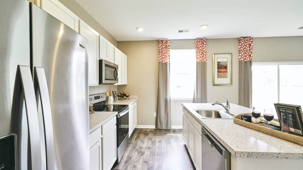 The well-designed gourmet kitchen features stainless steel appliances.