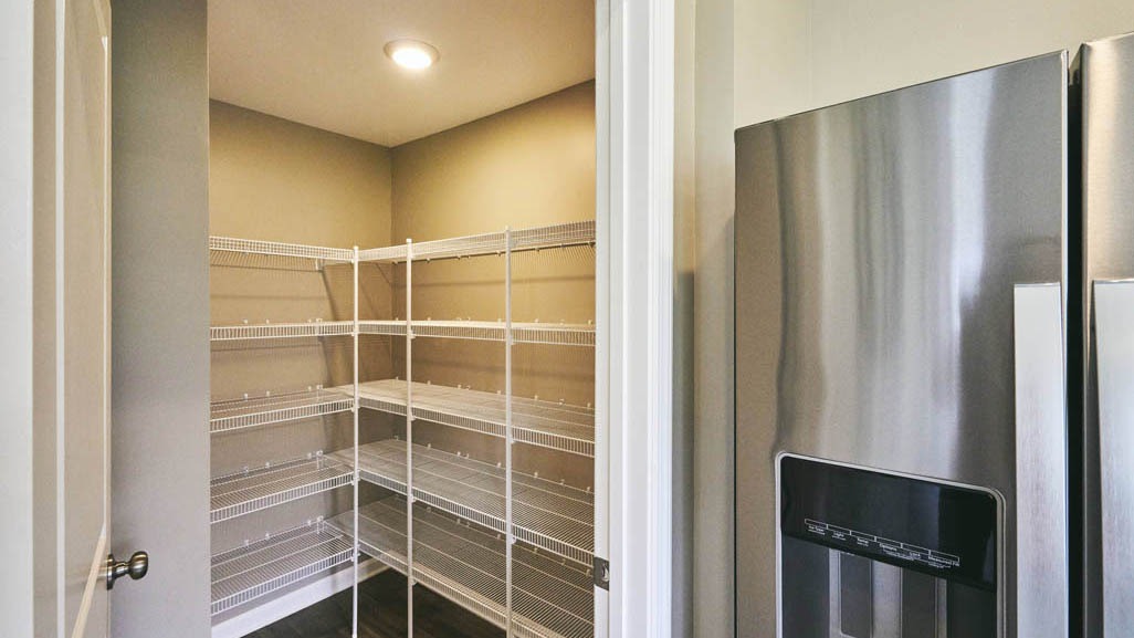 The well-designed gourmet kitchen features an oversized corner pantry.