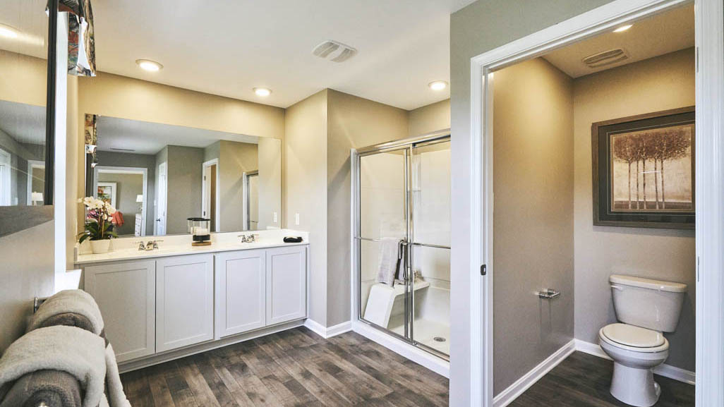 The impressive owner’s suite boasts an expansive bedroom and a contemporary owner’s bathroom with a large shower.