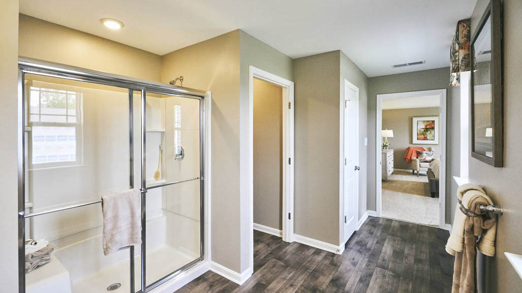 The impressive owner’s suite boasts an expansive bedroom and a contemporary owner’s bathroom with a large shower.