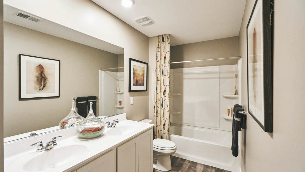 Three generously sized secondary bedrooms, and a spacious hall bathroom with double vanity complete the upstairs.