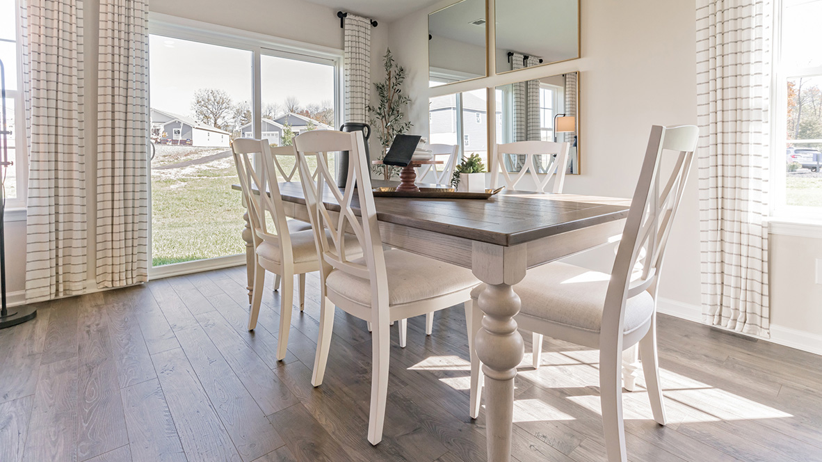 The ample great room and dining area both offer an abundance of natural light.