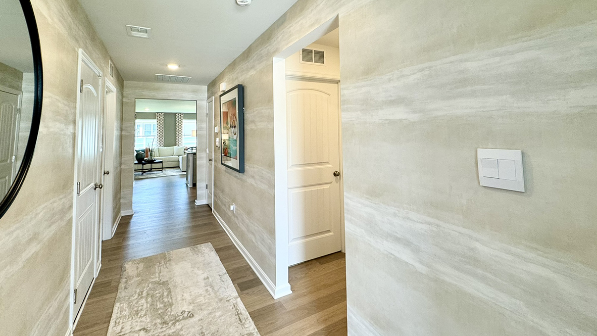 As you enter the inviting foyer, the short hallway will lead you inside the home.