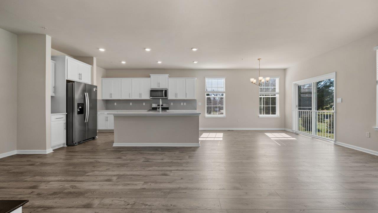 kitchen wiht white shaker cabinets and quartz counters