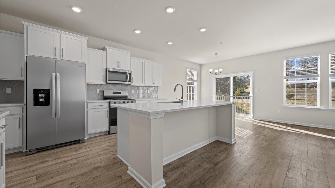 kitchen with shaker white cabinets and central island
