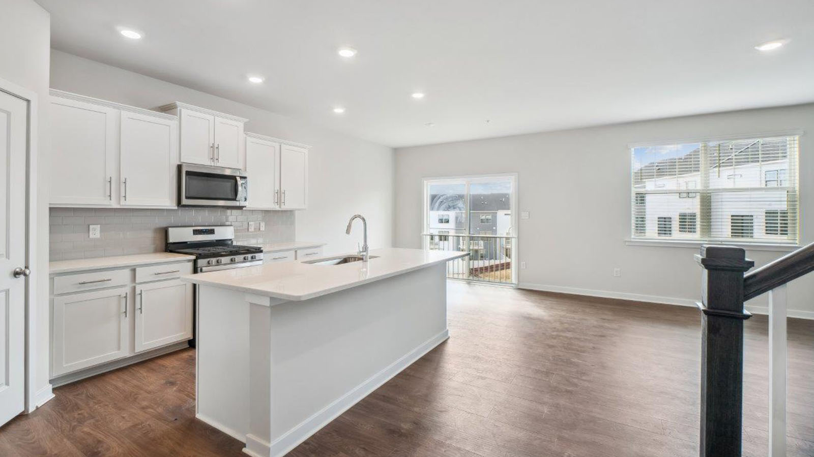 open concept kitchen with white shaker cabinets