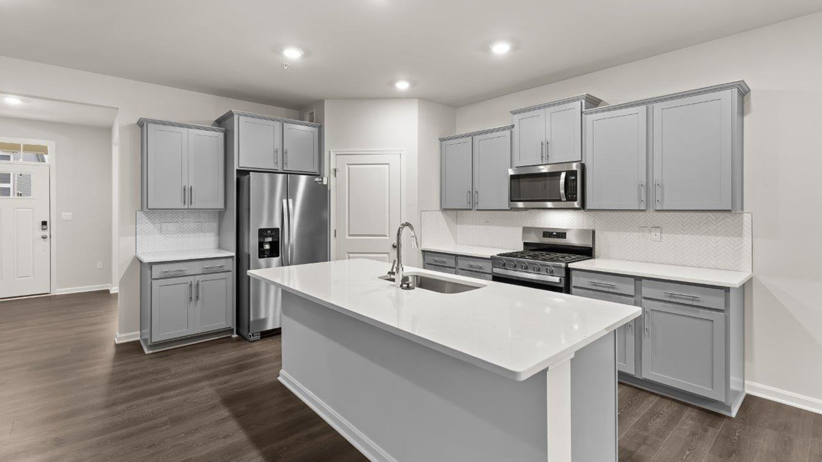 kitchen with shaker style cabinets and quartz counters
