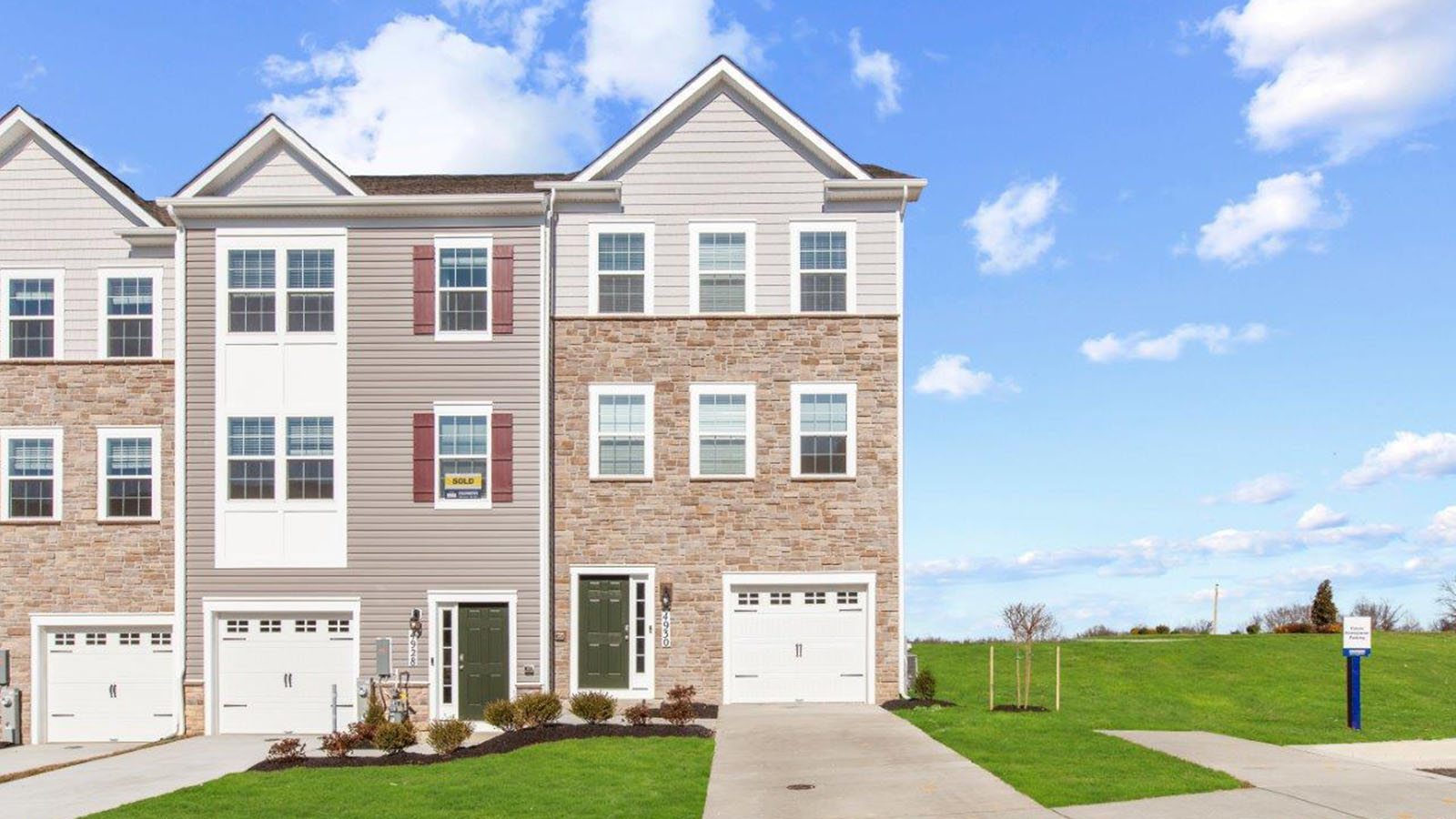 three story townhome with stone detail