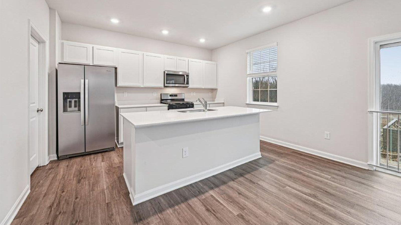 kitchen with white shaker style cabinets and quartz counters