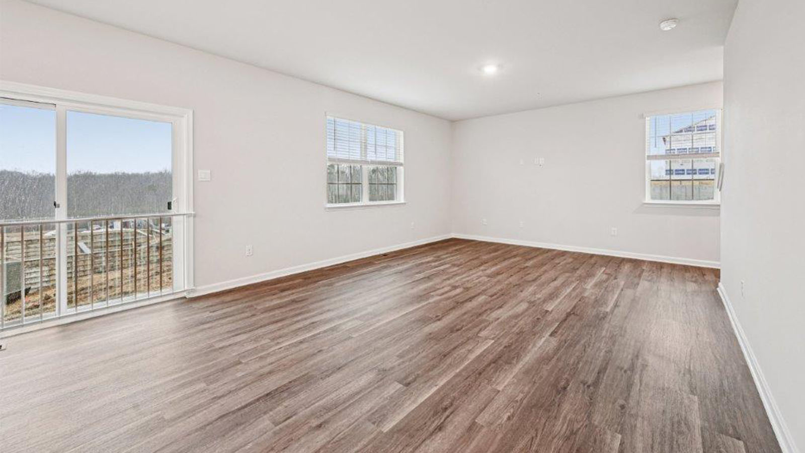 spacious living room leading to sliding back door
