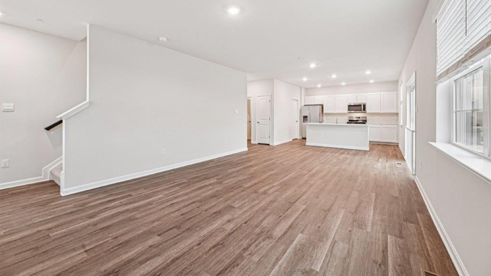 open concept living room with LVP