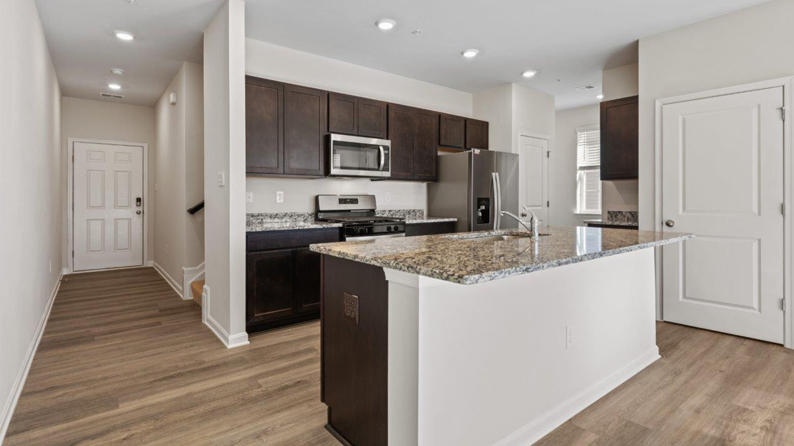 front entrance leading into open concept kitchen