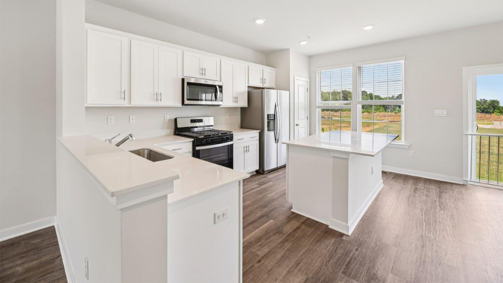 white shaker style kitchen cabinets and quartz counters