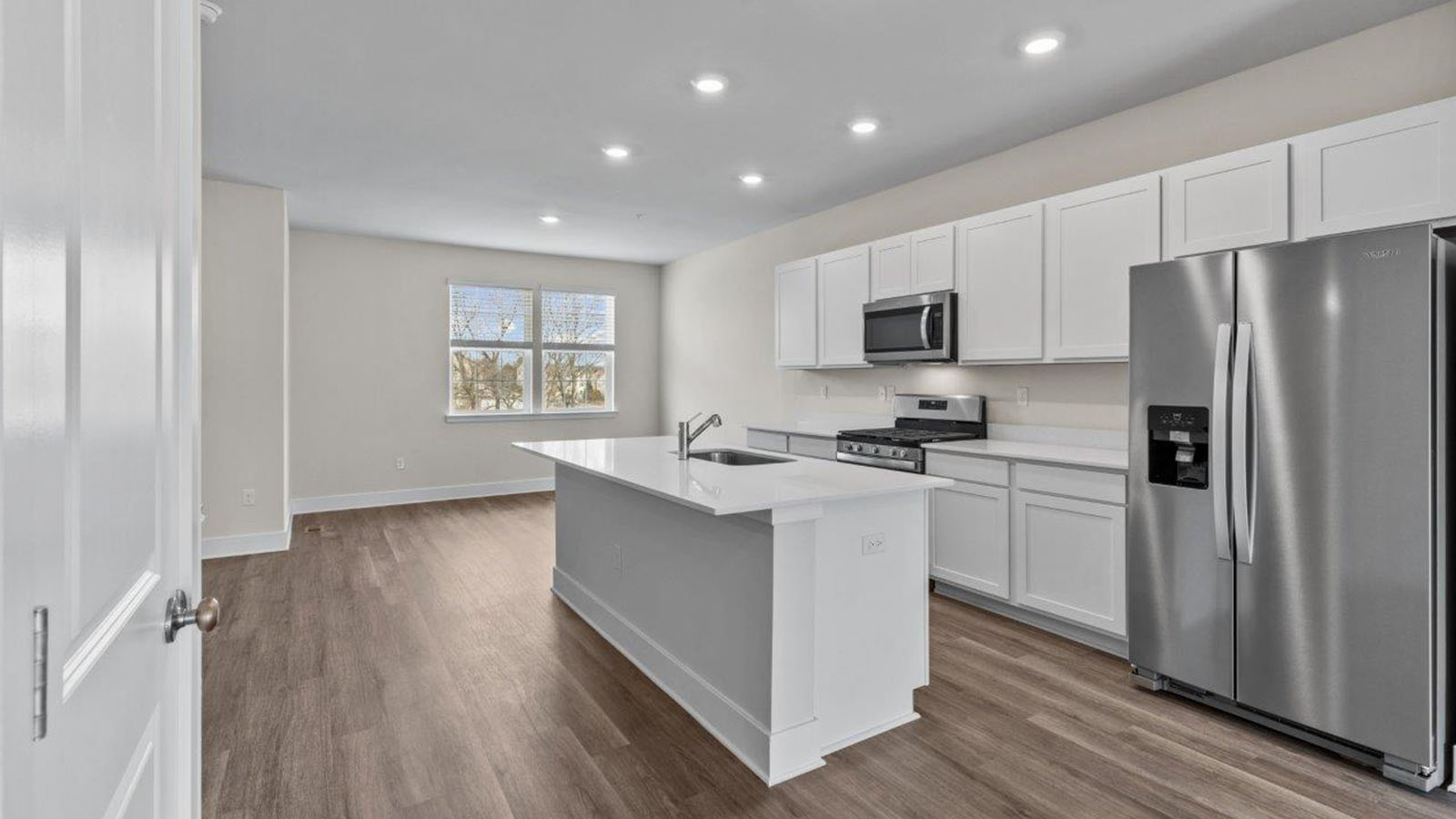 white shaker style kitchen cabinets and quartz counters