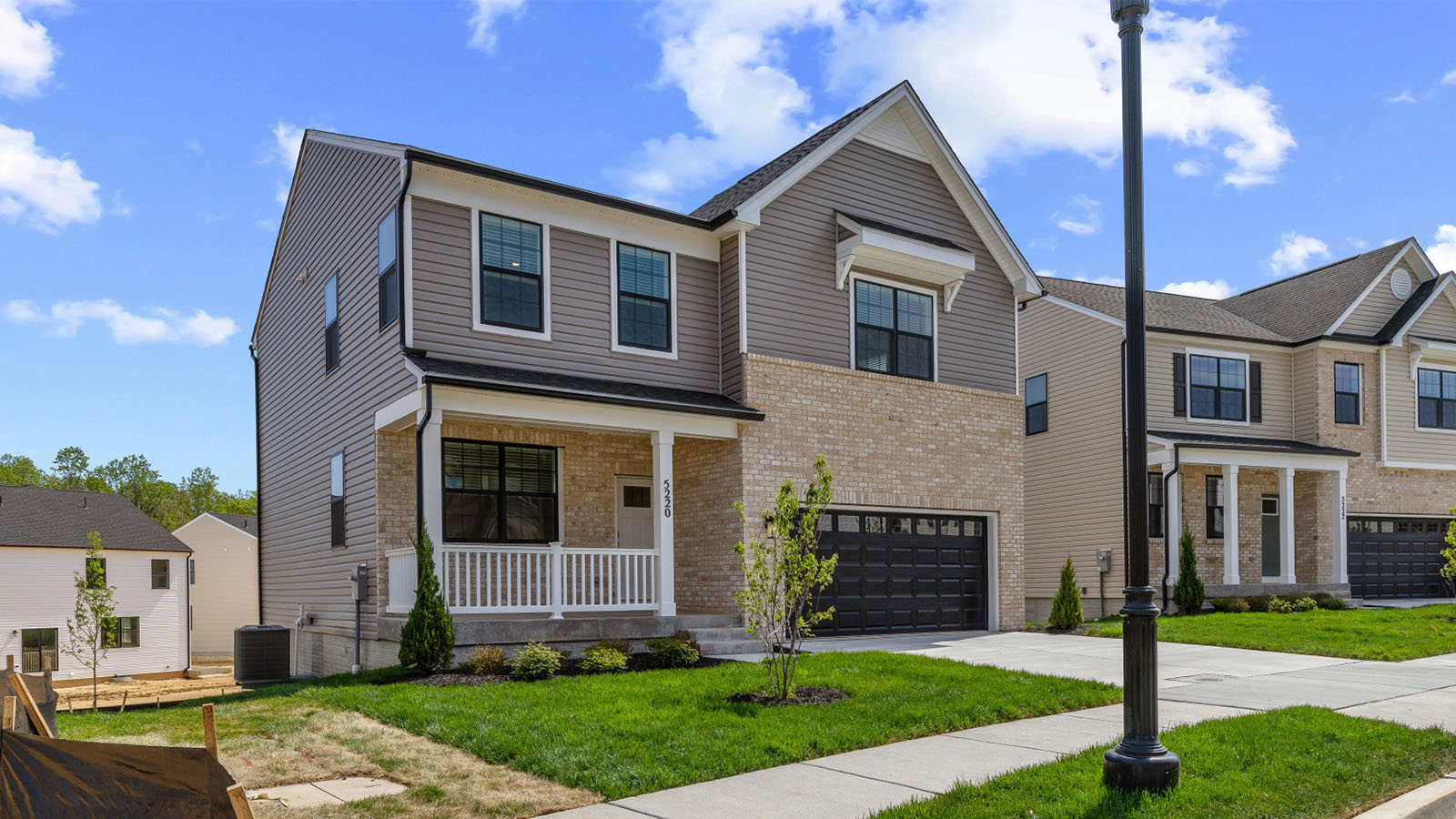 two car garage colonial home with brick