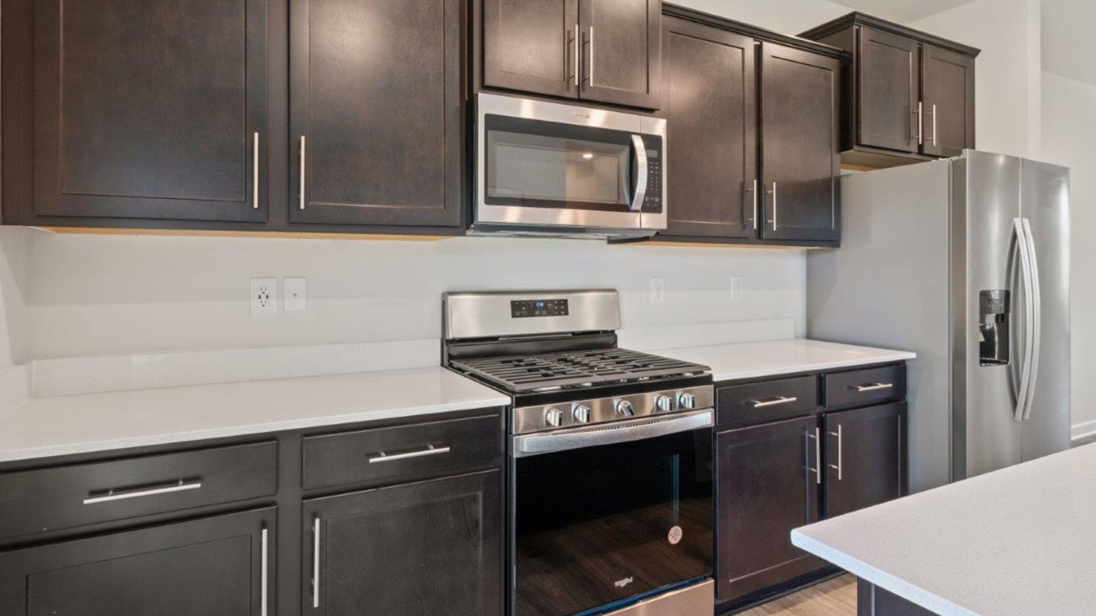 dark espresso cabinets with central quartz island