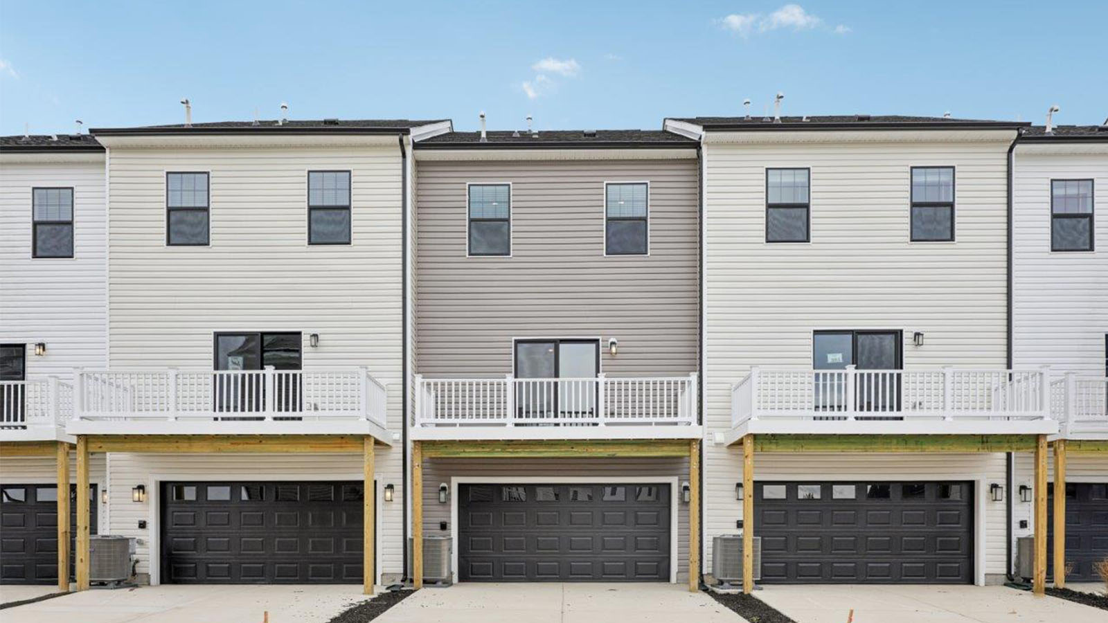 rear of townhome with two car garage