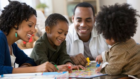 african american family playing board game