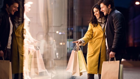 young couple shopping with bags in hand
