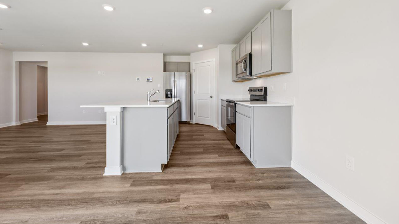 Kitchen with grey cabinets and quartz counters