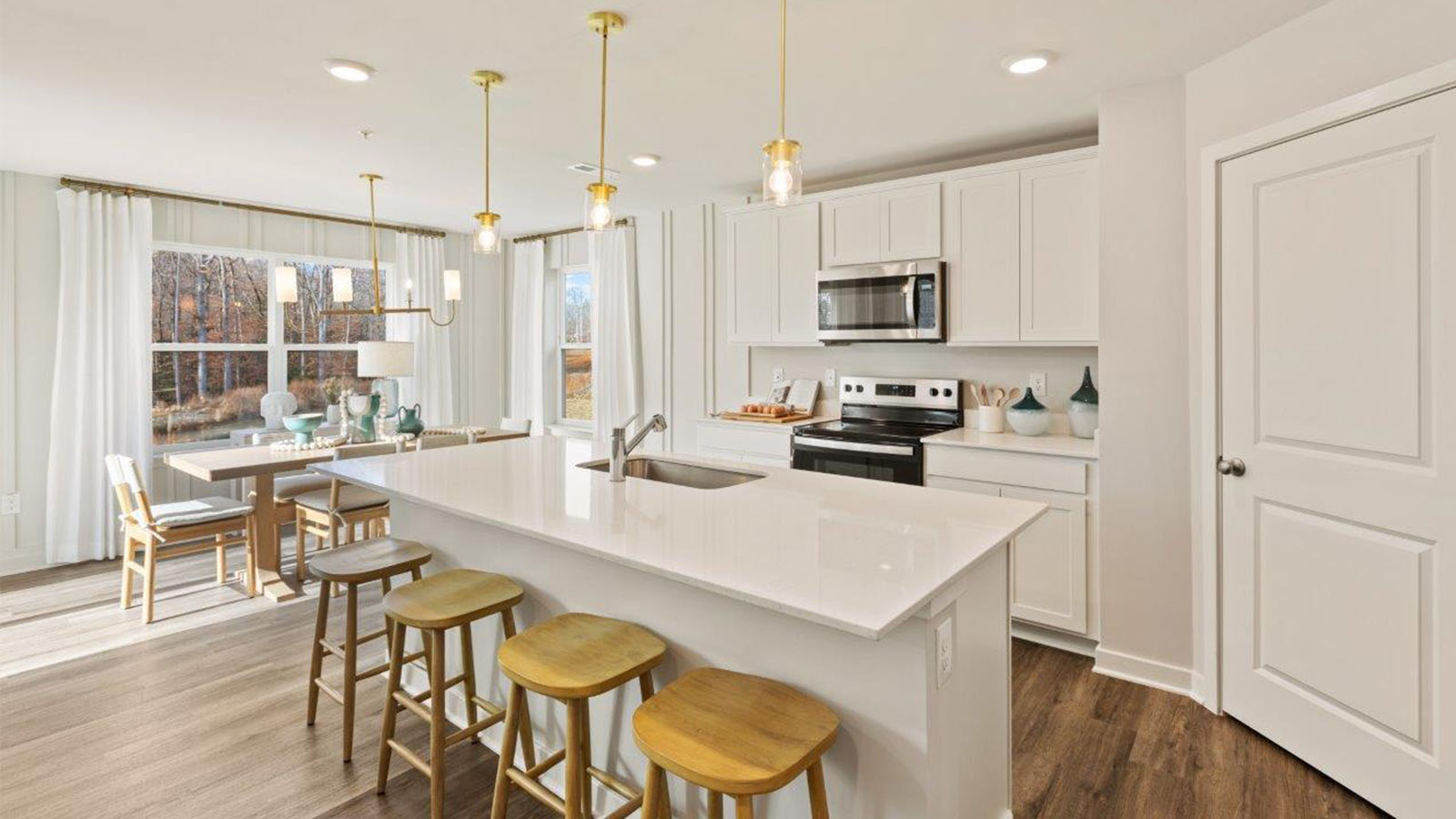 spacious kitchen with white shaker style cabinets