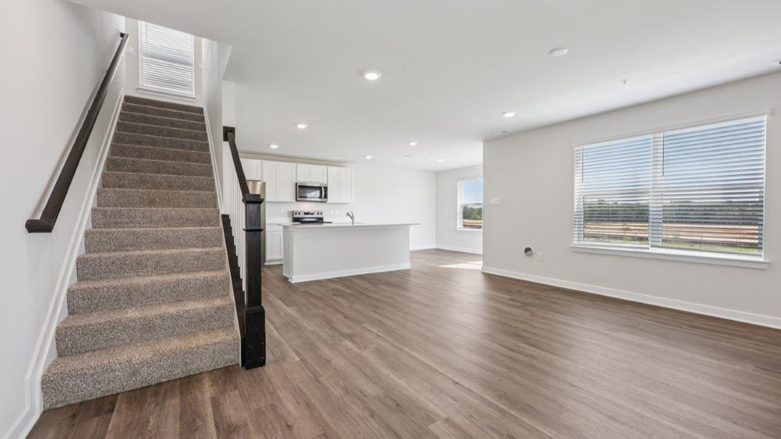 open concept living area leading into kitchen
