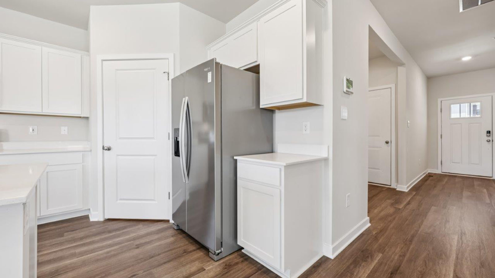 front door entry leading into open concept kitchen