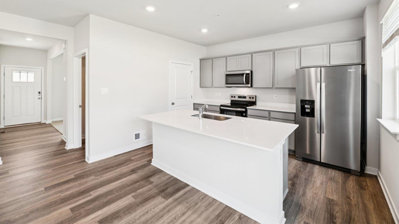 kitchen with grey shaker cabinets and quartz counters