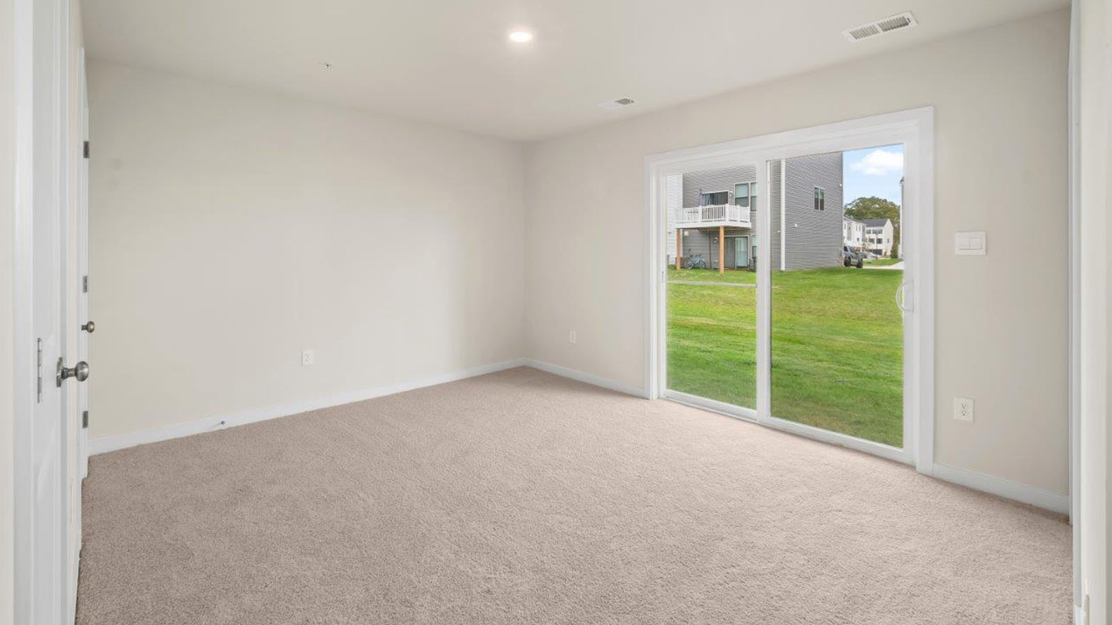 lower level bedroom with sliding back door