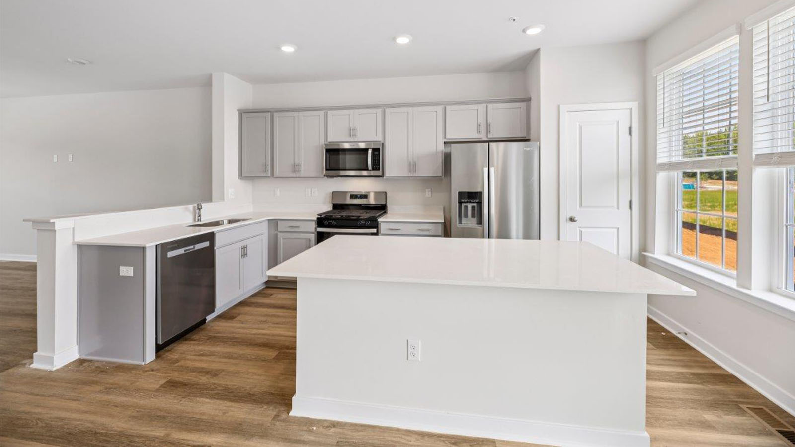 kitchen with grey shaker cabinets and central island