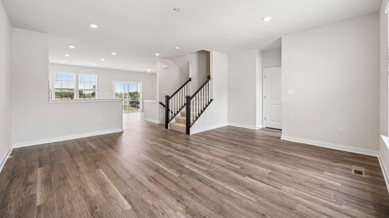 open concept living room with luxury vinyl plank floors