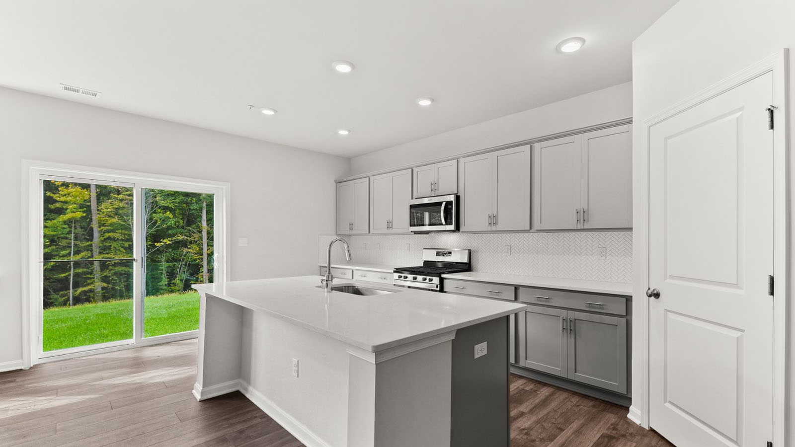 kitchen with grey shaker cabinets and quartz counters