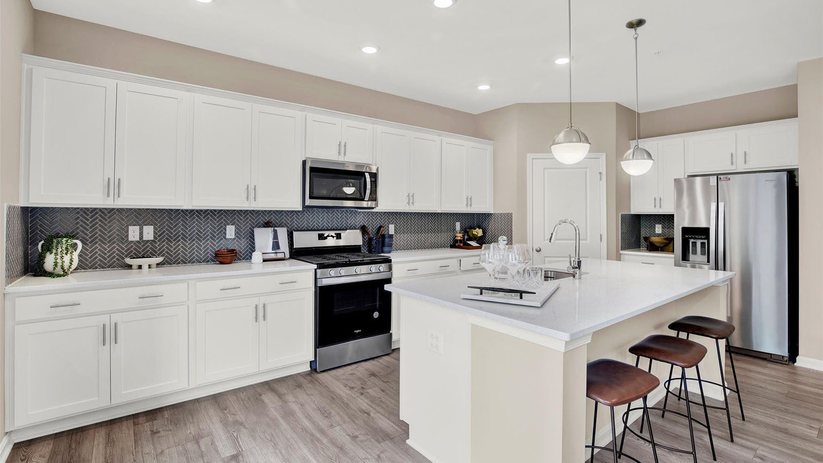 spacious kitchen with white shaker cabinets