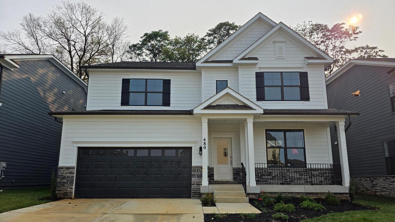 exterior with porch and two car garage