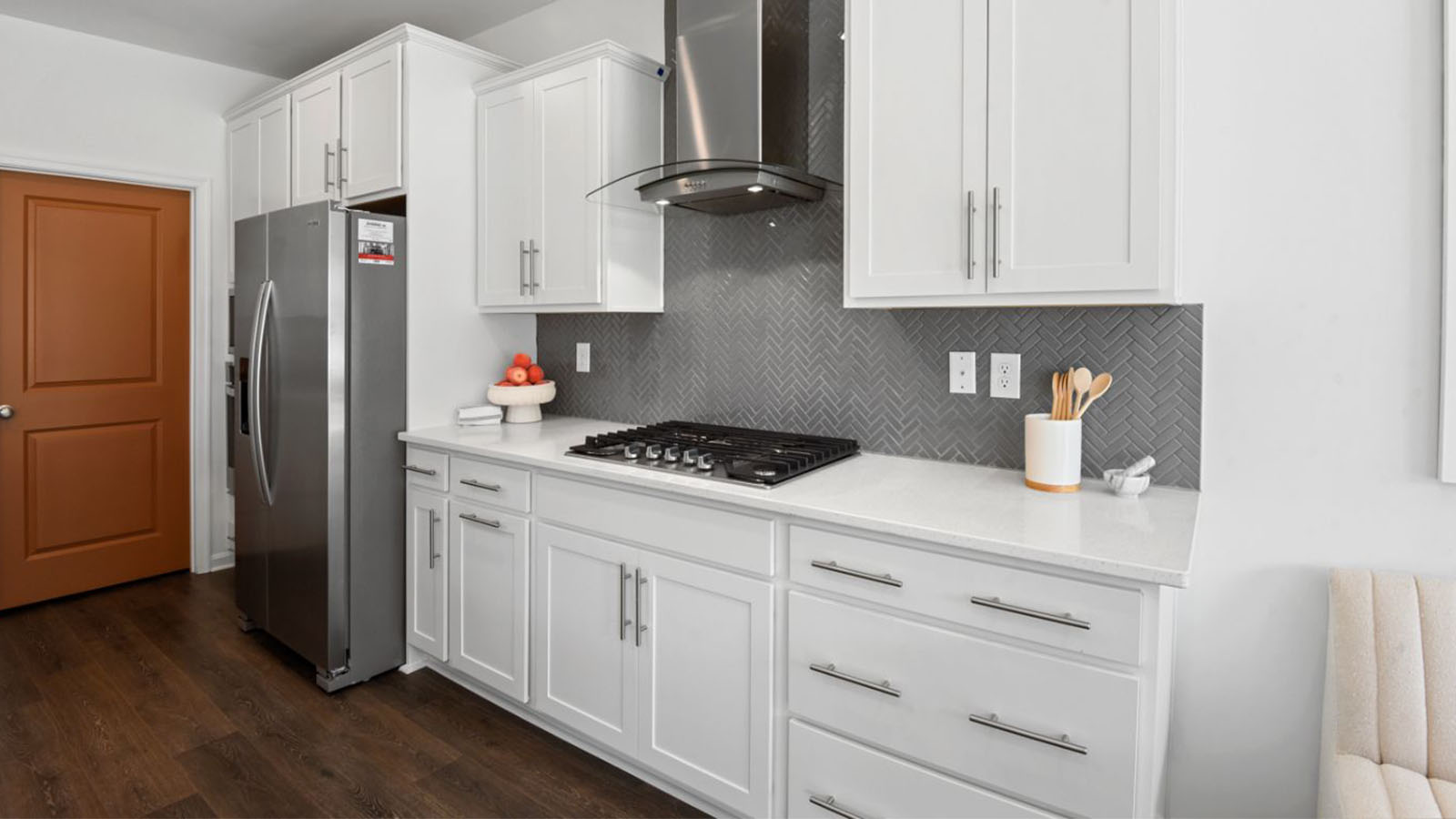 herringbone backsplash and stainless steel appliances