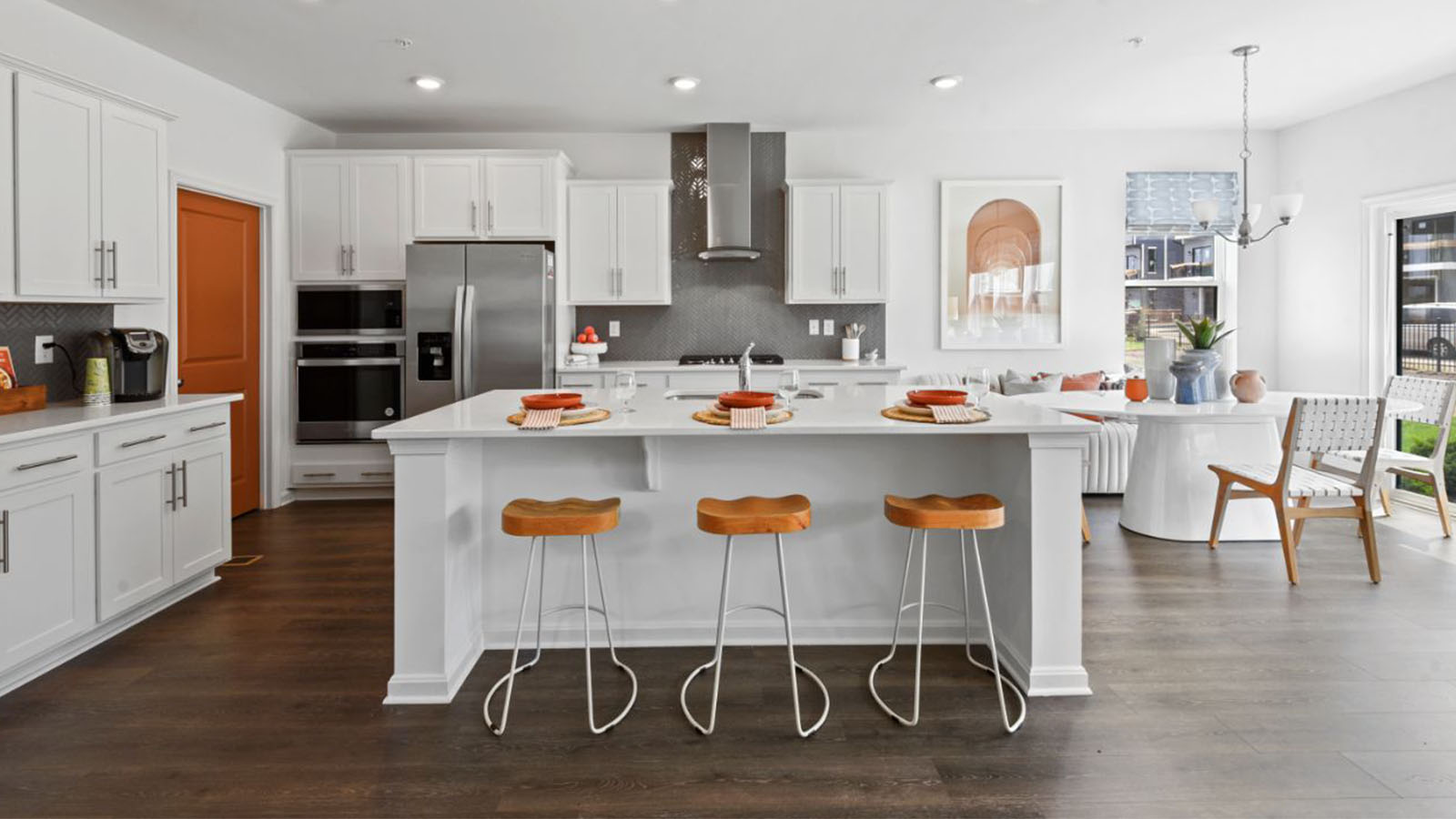 island with seating facing glass hood fan