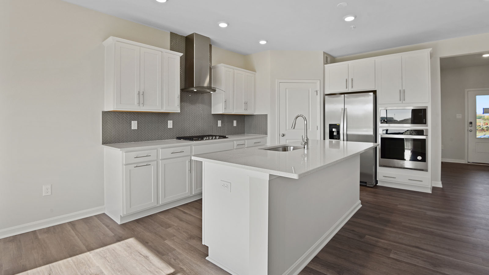 kitchen with white shaker cabinets and quartz counters
