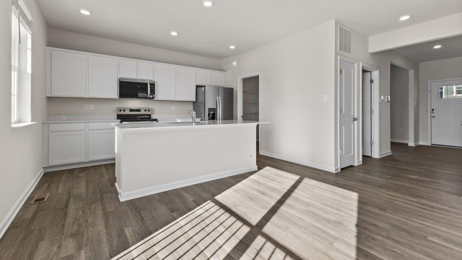 kitchen wiht white shaker cabinets and quartz counters