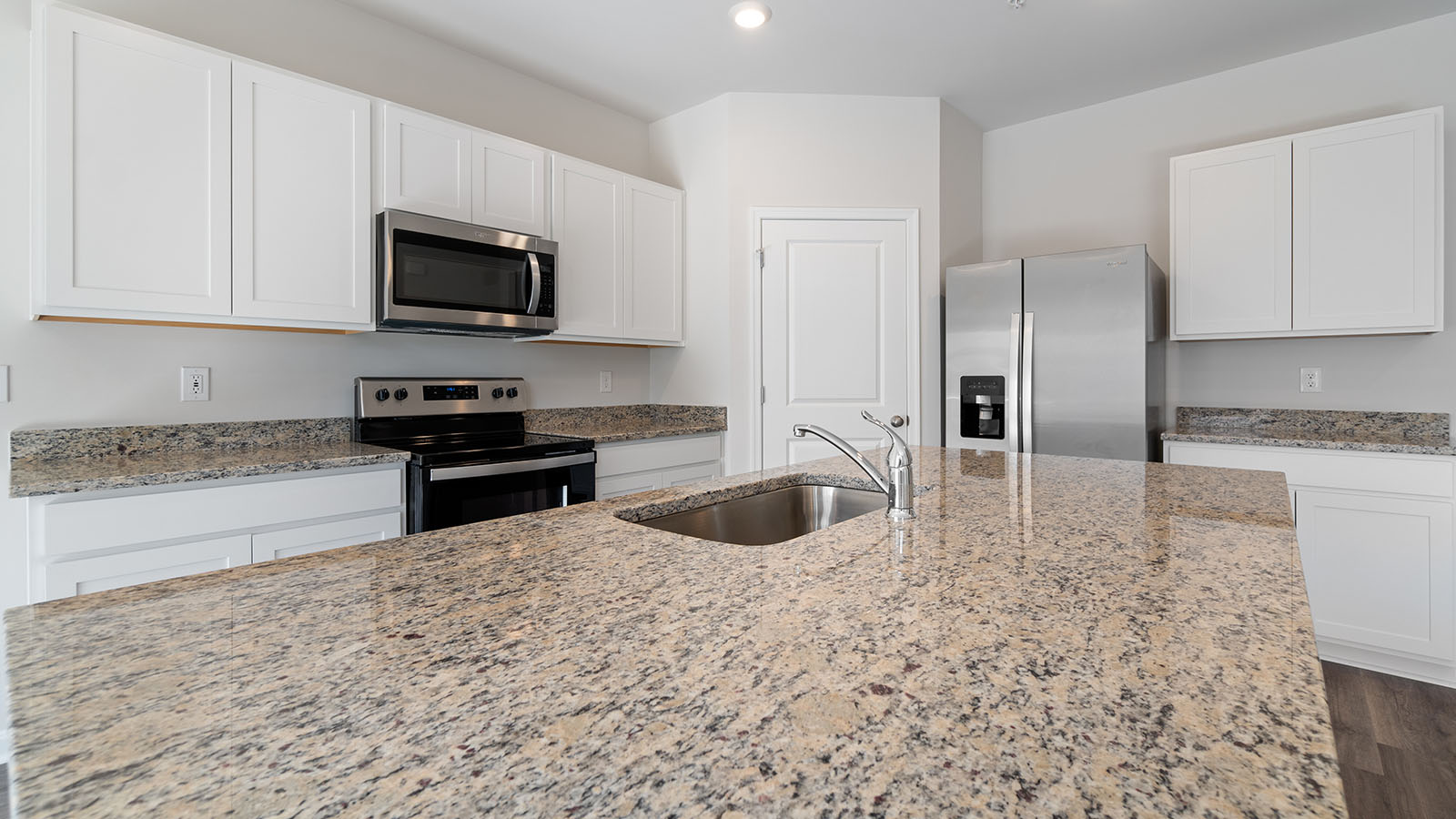 white shaker cabinets with stainless steel appliances