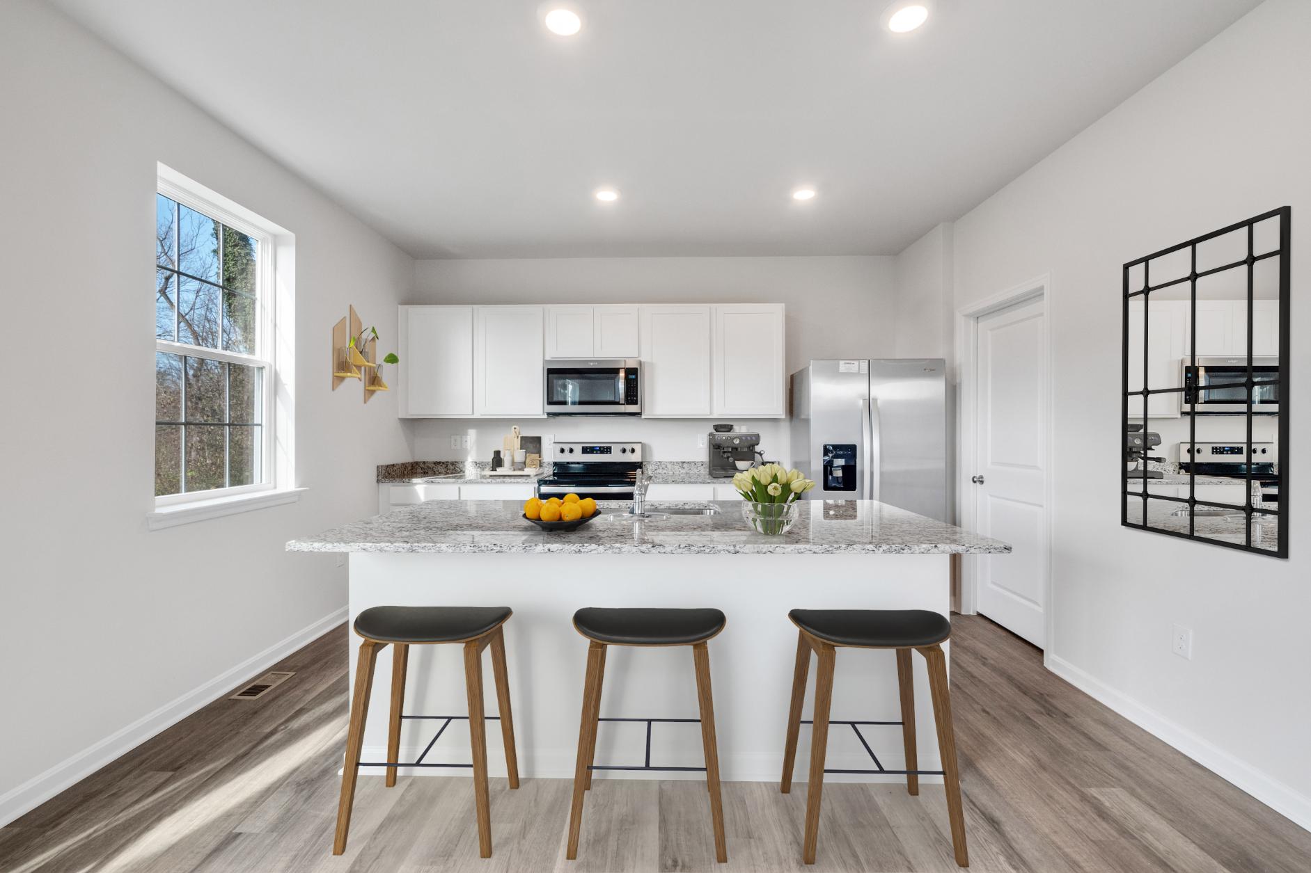 Galen plan kitchen bar with barstools looking into kitchen