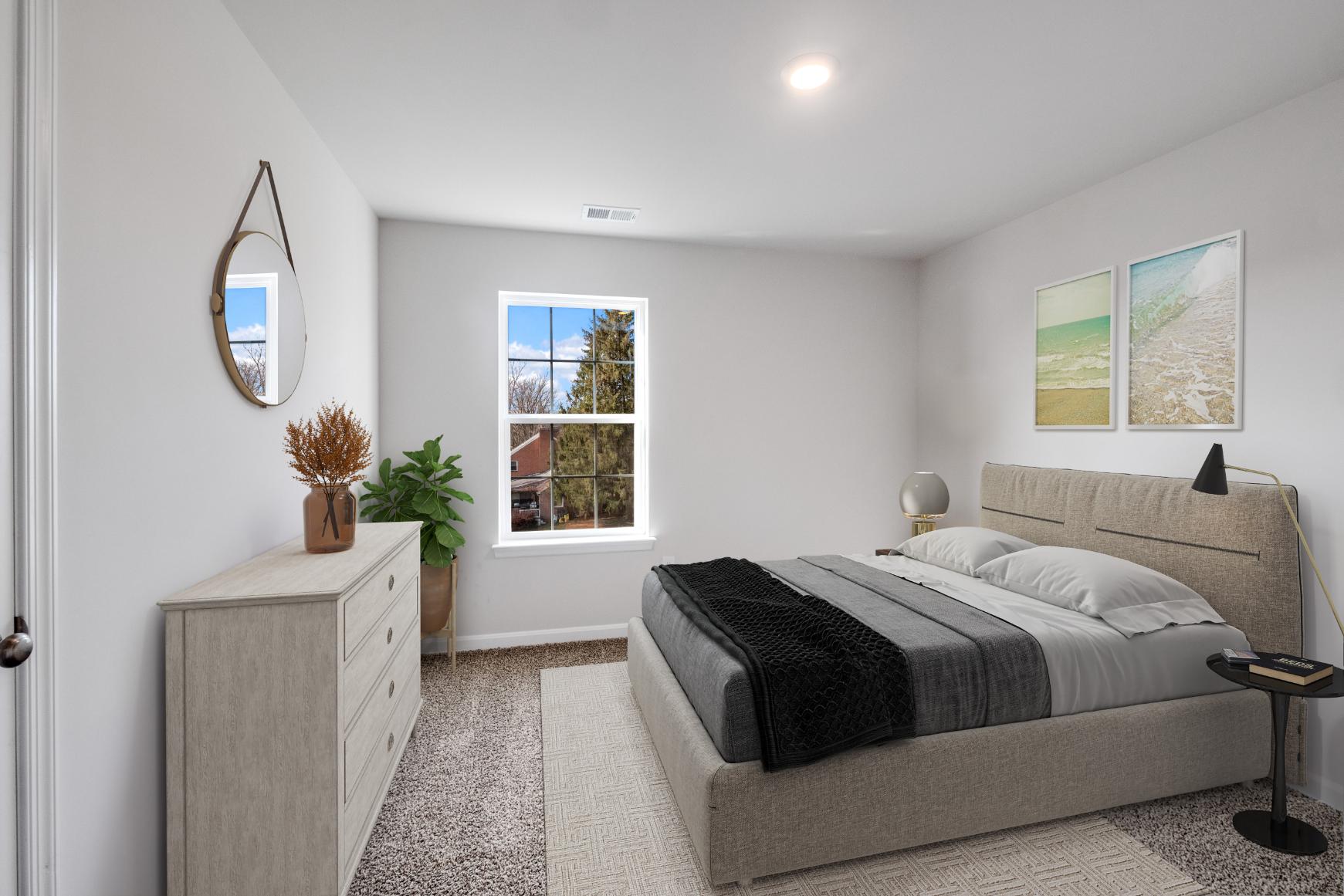 Galen plan bedroom with bed, dresser, and window