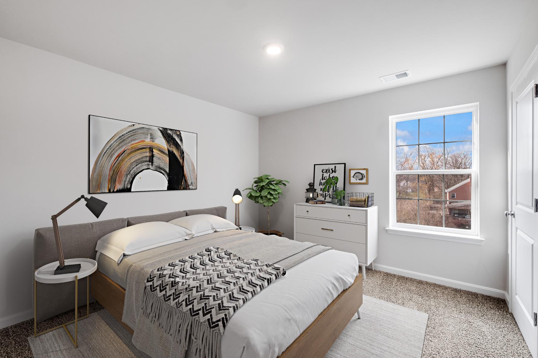 Galen plan bedroom with bed, dresser, and window