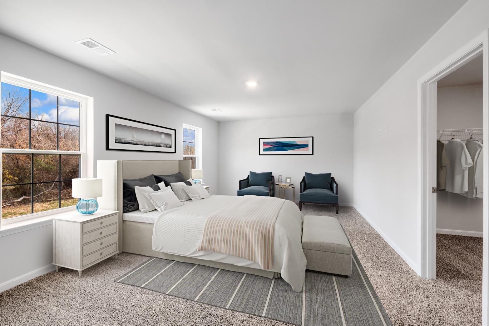 Galen plan bedroom with bed, dresser, footboard and window, looking into closet