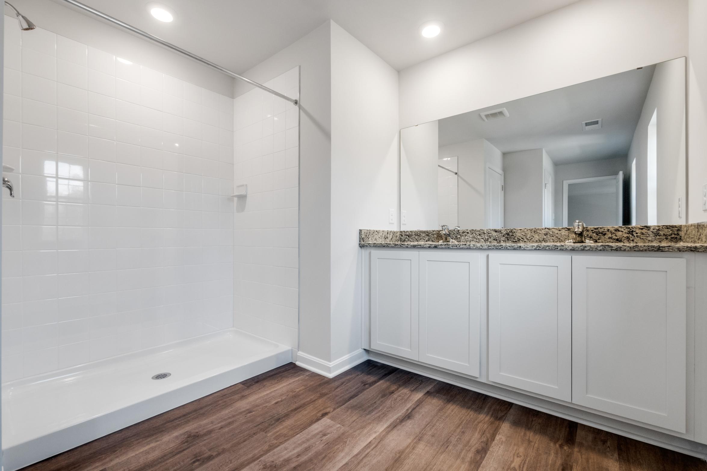 Galen plan bathroom shower and sinks with cabinets