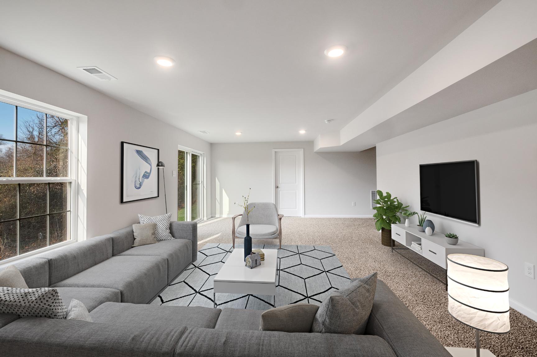 Galen plan living room with couch, loveseat, tv stand, tv, a chair and window