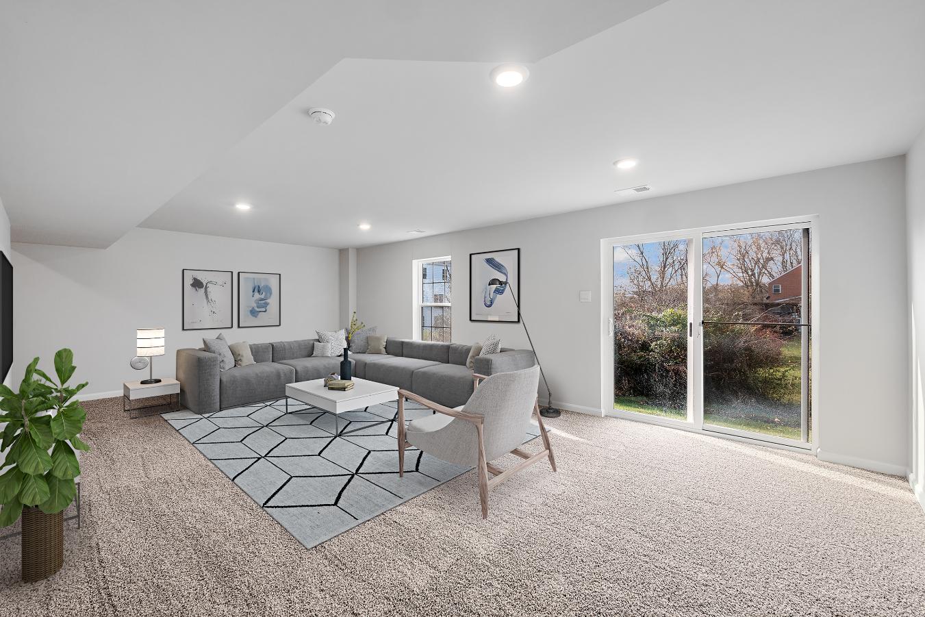 Galen plan living room with couch, love seat, coffee table, and sliding glass door