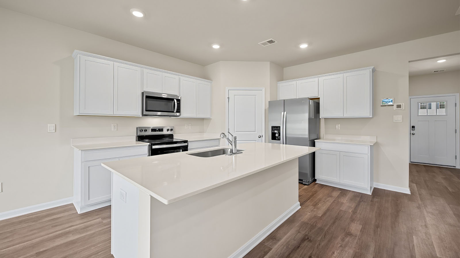 kitchen with white shaker cabinets and quartz counters